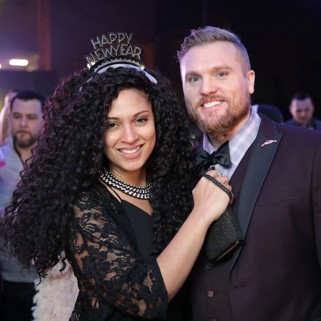 Man and woman dressed up at New Year's Eve party.