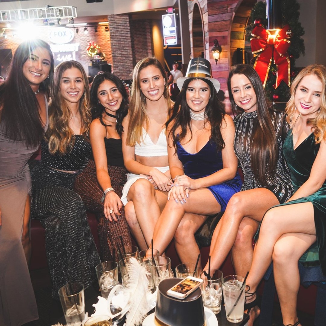 Group of young women dressed up at a New Year's Eve party.